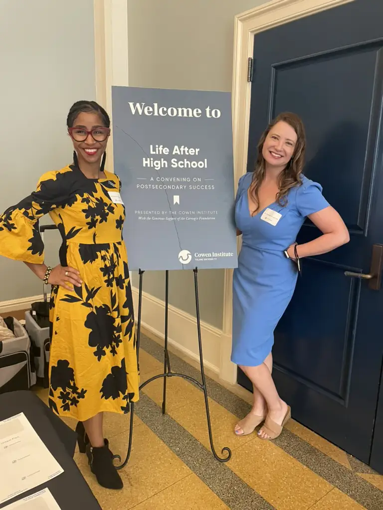 Amanda Kruger Hill and Mia Gonzales Washington posing and smiling next to a Life After High School welcome sign